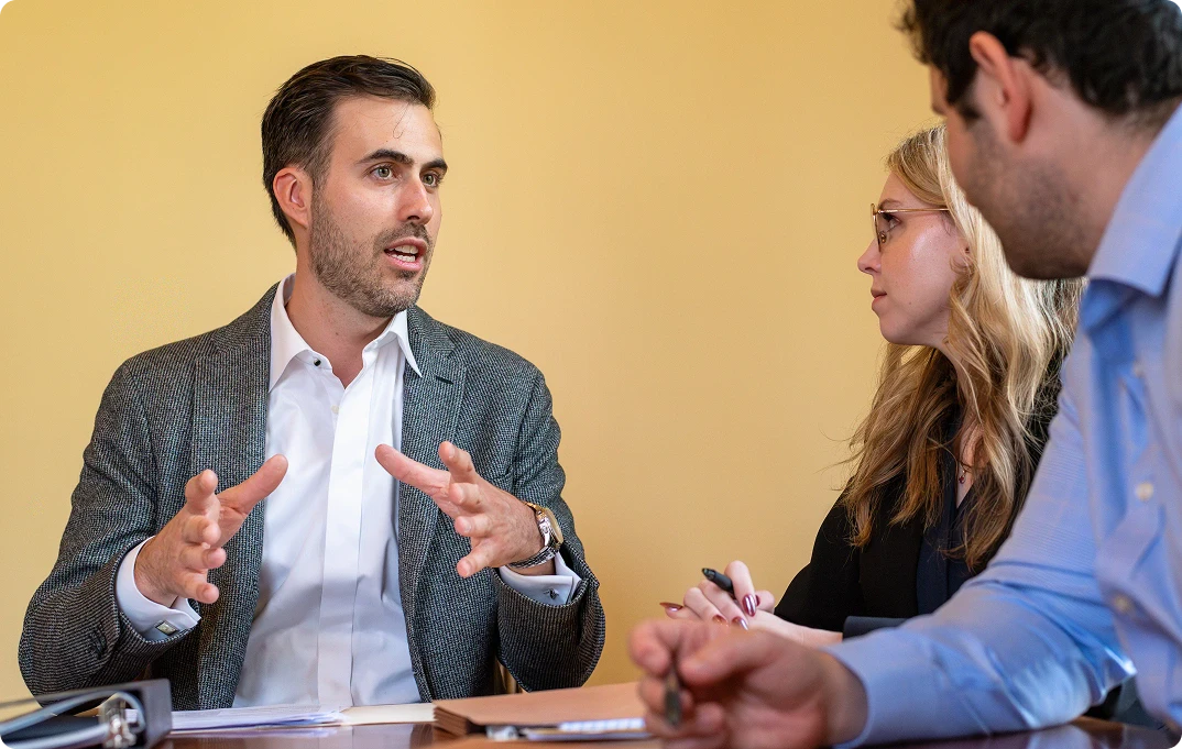 Elias Kohn having a discussion with clients